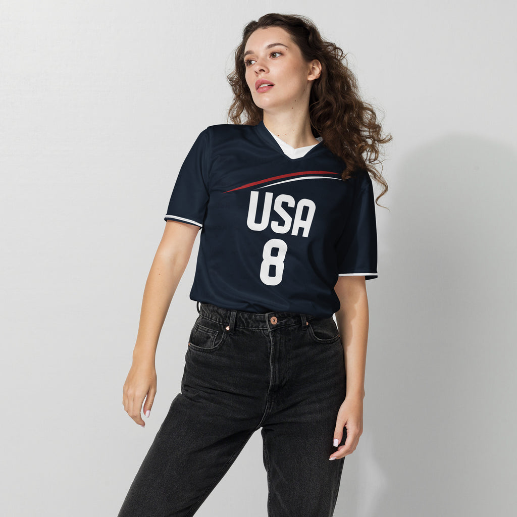 all-over-print-recycled-unisex-sports-jersey-USA-Midnight-Strike-soccer-jersey-navy-base-with-red-and-white-diagonal-strike-premium-national-team-fanwear-female-model-front-view