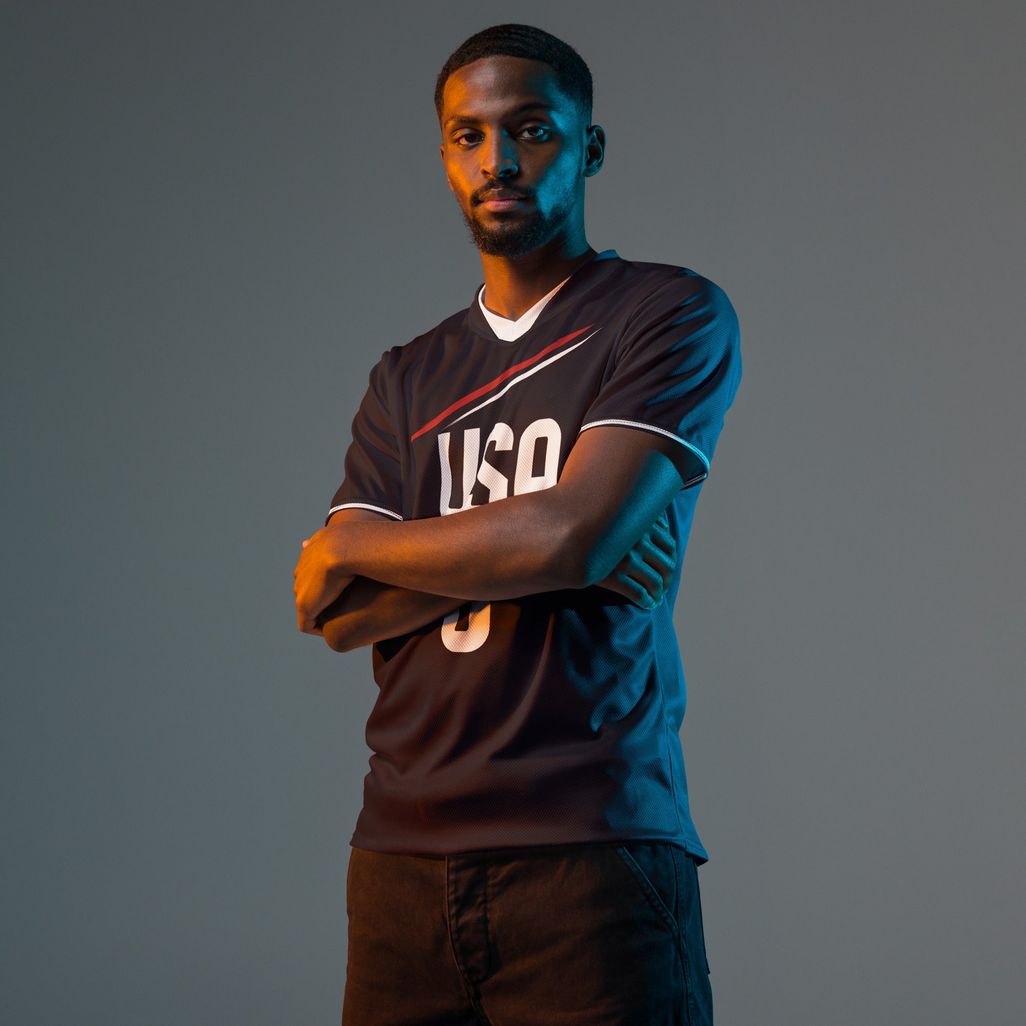 all-over-print-recycled-unisex-sports-jersey-USA-Midnight-Strike-soccer-jersey-navy-base-with-red-and-white-diagonal-strike-premium-national-team-fanwear-male-front-male-model-view
