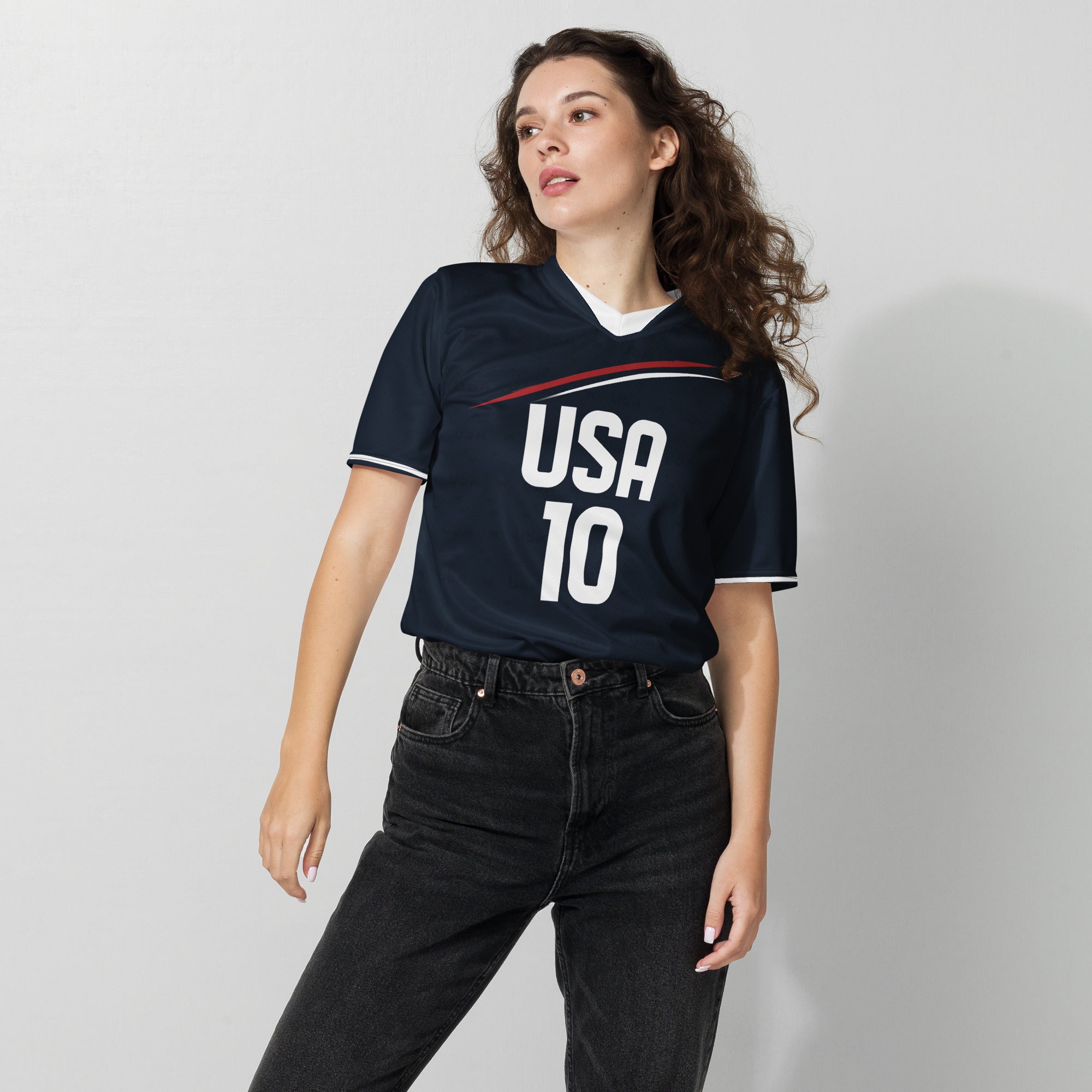 all-over-print-recycled-unisex-sports-jersey-_10-USA-Midnight-Strike-soccer-jersey-navy-base-with-red-and-white-diagonal-strike-premium-national-team-fanwear-female-model-front-view