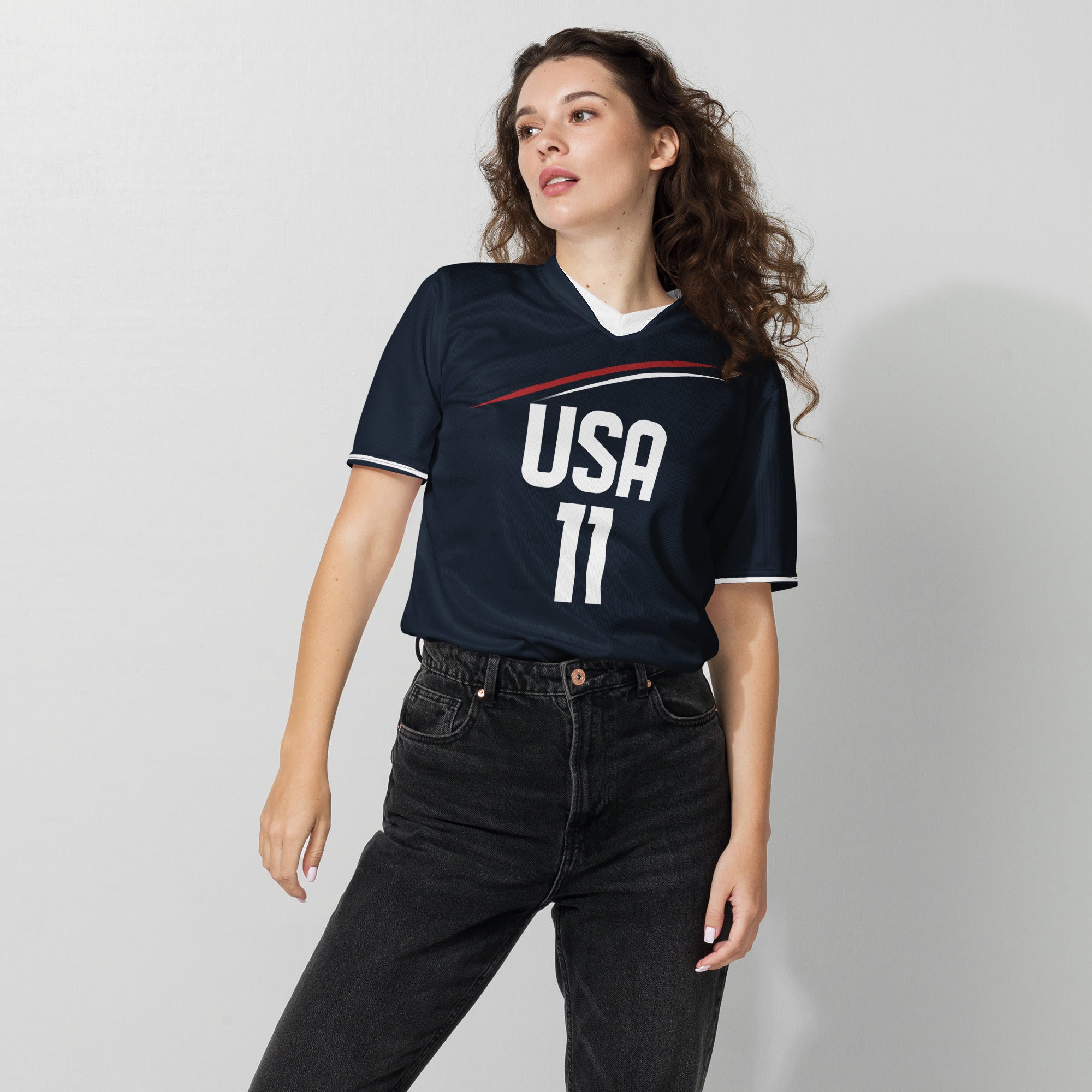 all-over-print-recycled-unisex-sports-jersey-_11-USA-Midnight-Strike-soccer-jersey-navy-base-with-red-and-white-diagonal-strike-premium-national-team-fanwear-female-model-front-view