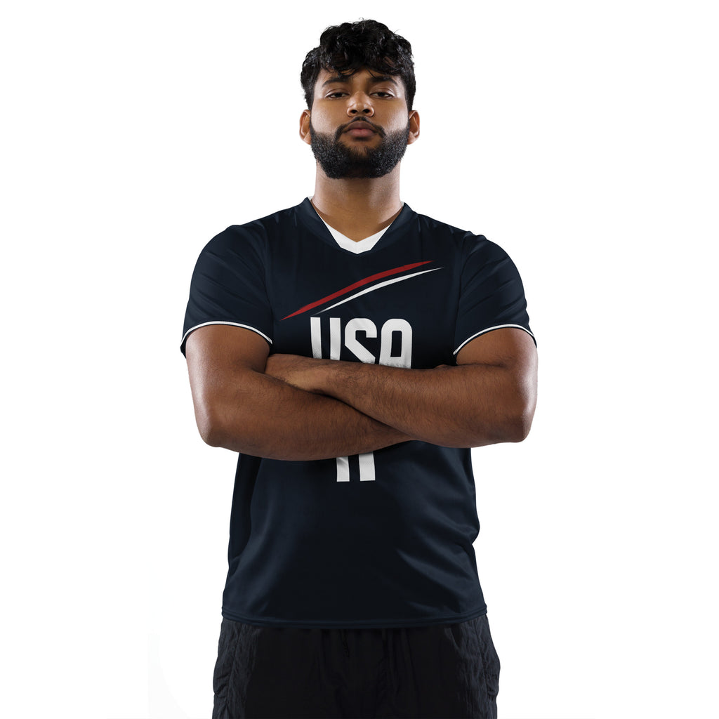 all-over-print-recycled-unisex-sports-jersey-_11-USA-Midnight-Strike-soccer-jersey-navy-base-with-red-and-white-diagonal-strike-premium-national-team-fanwear-male-model-front-view