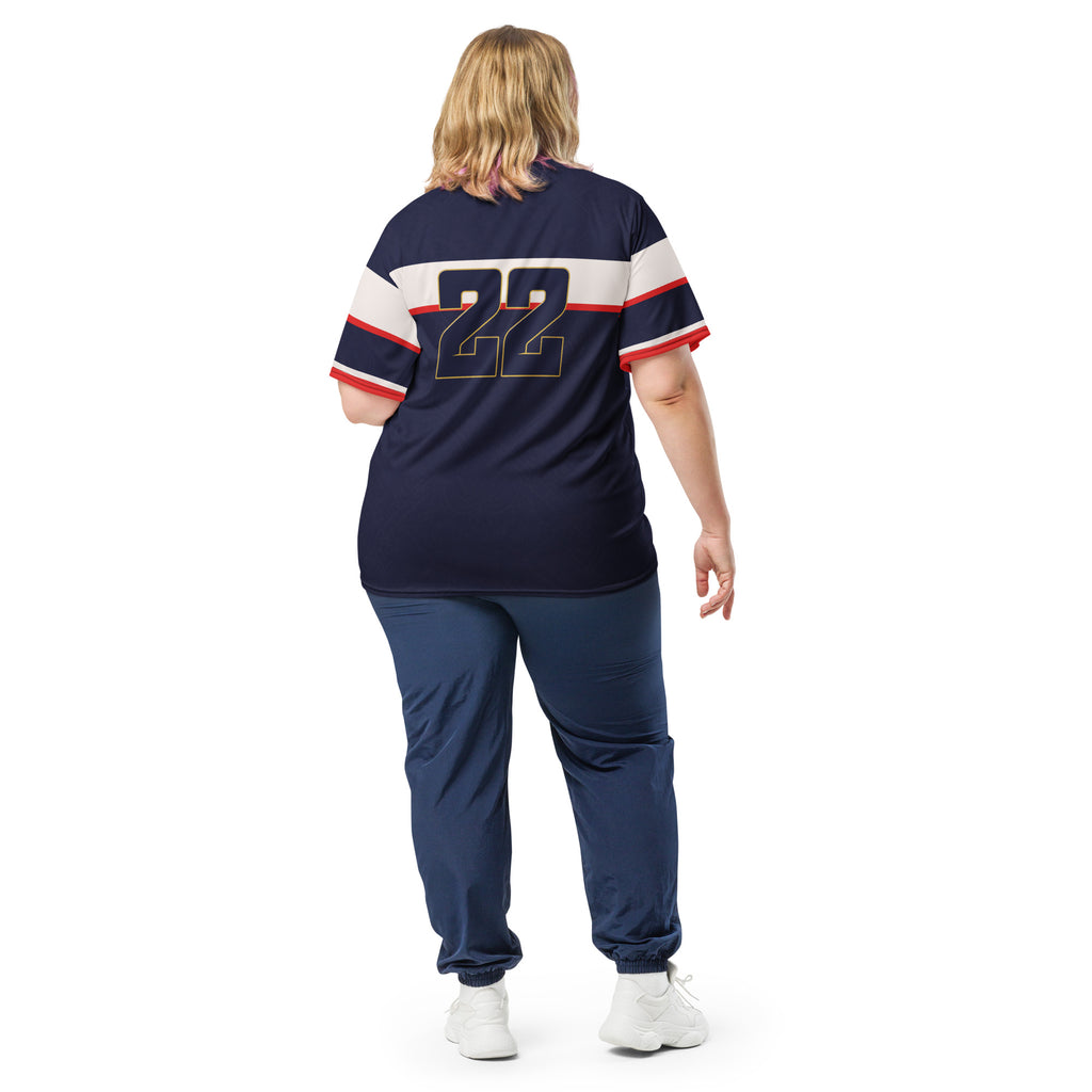 all-over-print-recycled-unisex-sports-jersey-France-Bleu-Majesté-edition-soccer-jersey-royal-blue-base-with-white-chest-band-and-gold-FRANCE-branding-premium-national-team-fanwear-model-back-view2-female-model