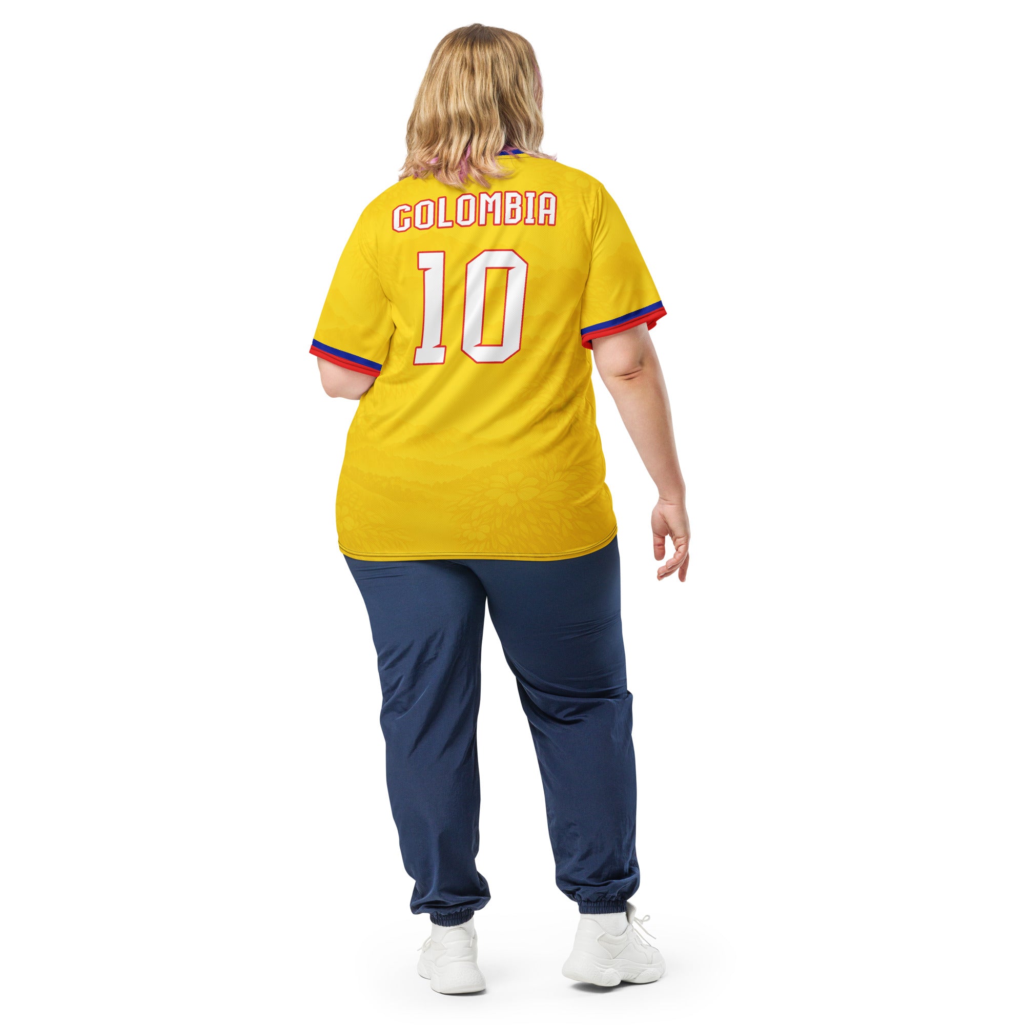 all-over-print-recycled-unisex-sports-jersey-Colombia-Pasión-Cafetera-soccer-jersey-golden-base-with-tricolor-sash-and-coffee leaf-motifs-premium-national-team-fanwear-model-back-view2-female-model
