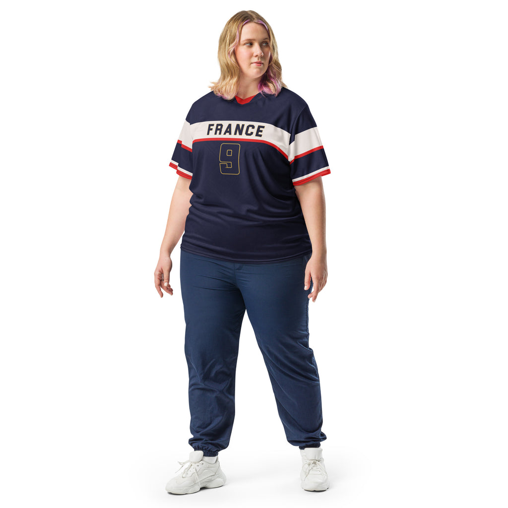 all-over-print-recycled-unisex-sports-jersey-France-Bleu-Majesté-edition-soccer-jersey-royal-blue-base-with-white-chest-band-and-gold-FRANCE-branding-premium-national-team-fanwear-model-front-view2-female-model