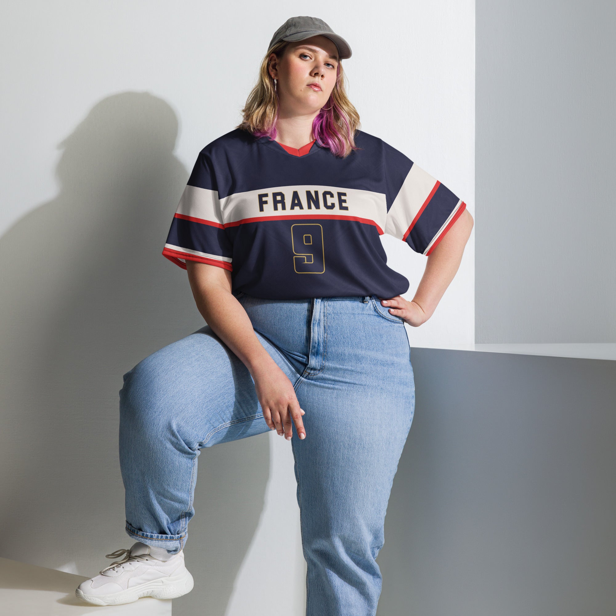 all-over-print-recycled-unisex-sports-jersey-France-Bleu-Majesté-edition-soccer-jersey-royal-blue-base-with-white-chest-band-and-gold-FRANCE-branding-premium-national-team-fanwear-model-front-view2-female