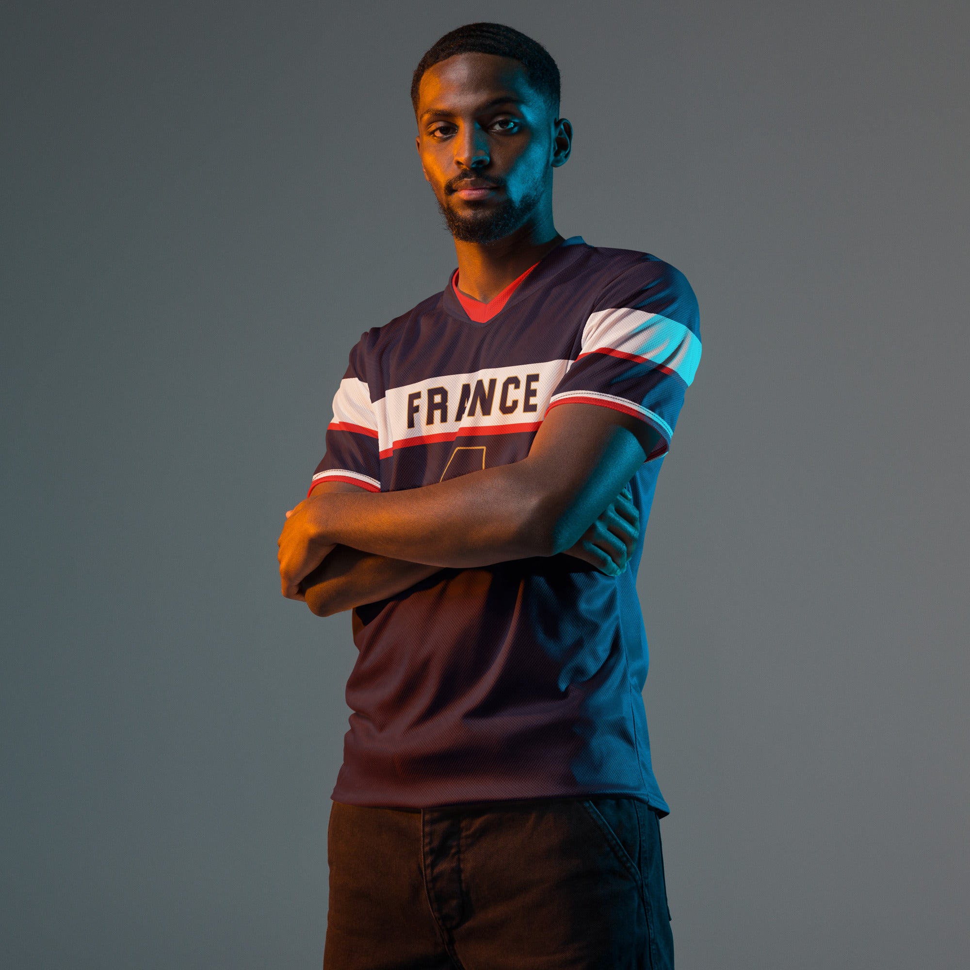 all-over-print-recycled-unisex-sports-jersey-France-Bleu-Majesté-edition-soccer-jersey-royal-blue-base-with-white-chest-band-and-gold-FRANCE-branding-premium-national-team-fanwear-model-front-view-male-model