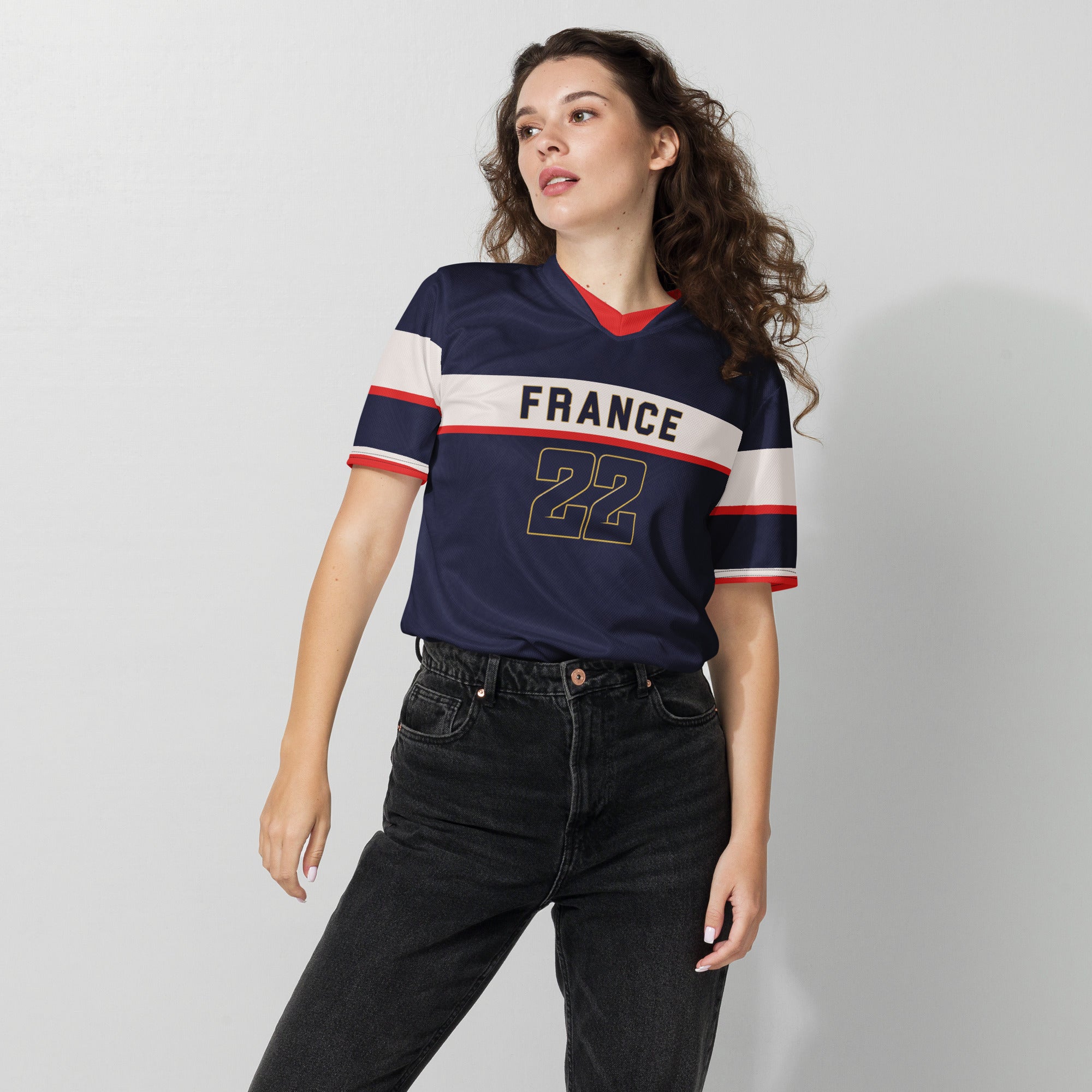 all-over-print-recycled-unisex-sports-jersey-France-Bleu-Majesté-edition-soccer-jersey-royal-blue-base-with-white-chest-band-and-gold-FRANCE-branding-premium-national-team-fanwear-female-model-front-view