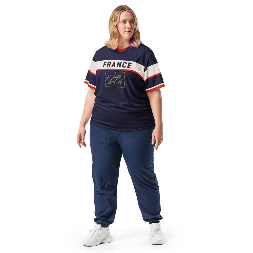 all-over-print-recycled-unisex-sports-jersey-France-Bleu-Majesté-edition-soccer-jersey-royal-blue-base-with-white-chest-band-and-gold-FRANCE-branding-premium-national-team-fanwear-model-front-view2-female-model