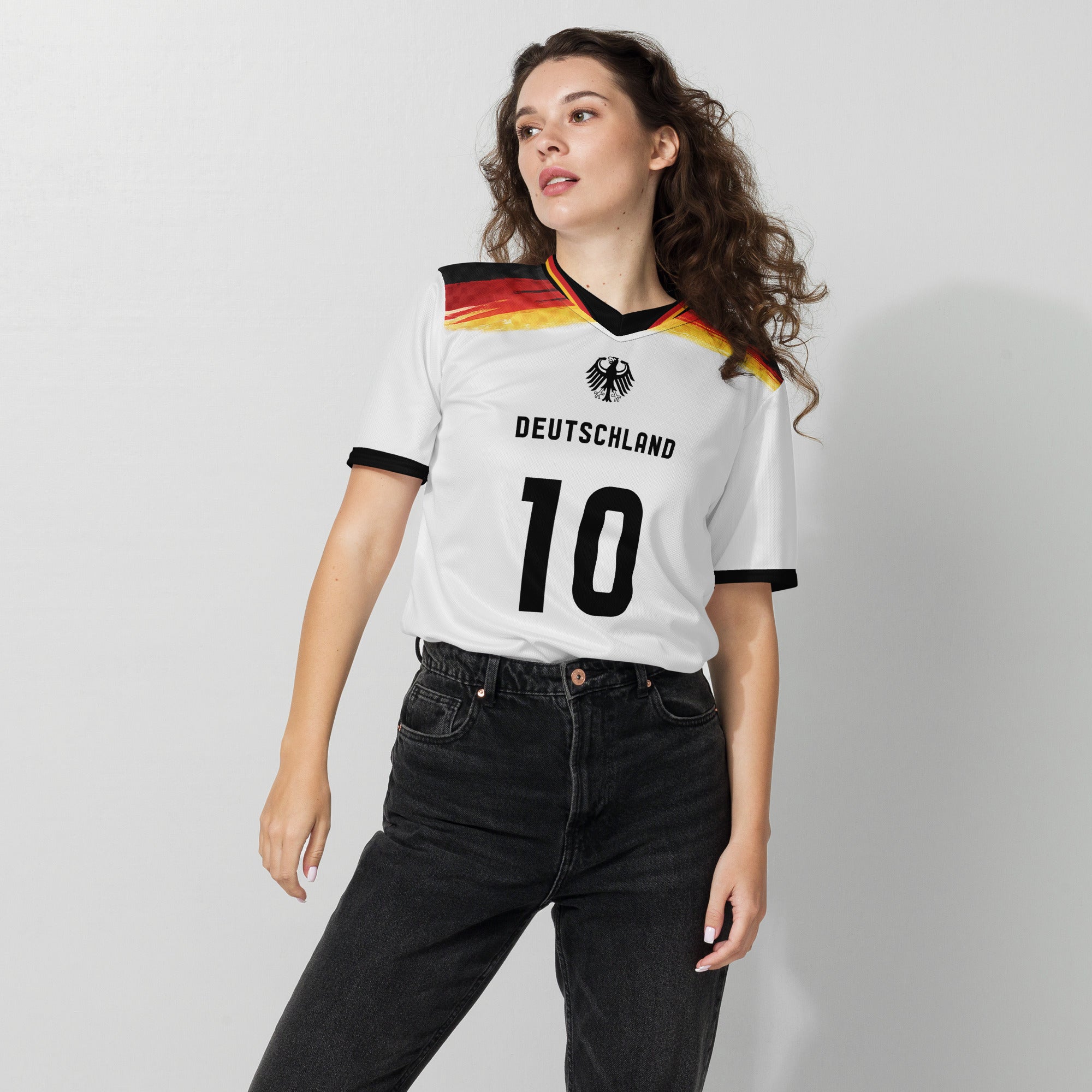 all-over-print-recycled-unisex-sports-jersey-#5-Germany Horizon-edition-soccer-jersey-black-sleeves-with-tricolor-brushstroke-band-and-gold red black-trim-pattern-premium-national-team-fanwear-female-model-front-view