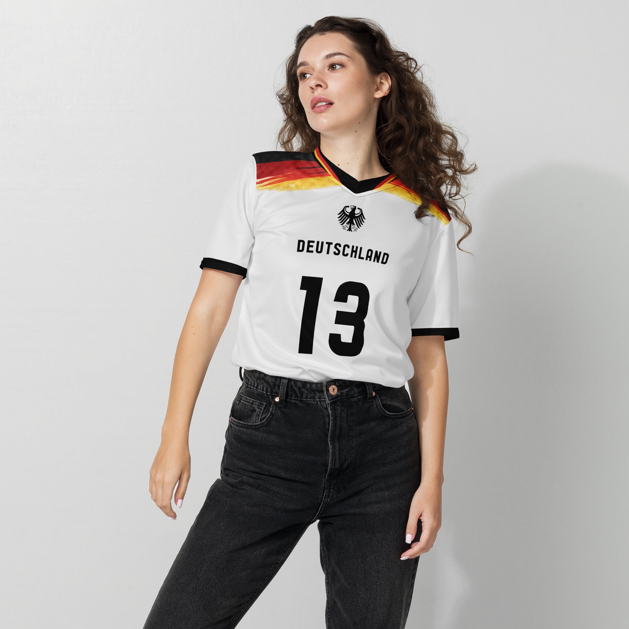all-over-print-recycled-unisex-sports-jersey-#5-Germany Horizon-edition-soccer-jersey-black-sleeves-with-tricolor-brushstroke-band-and-gold red black-trim-pattern-premium-national-team-fanwear-female-model-front-view