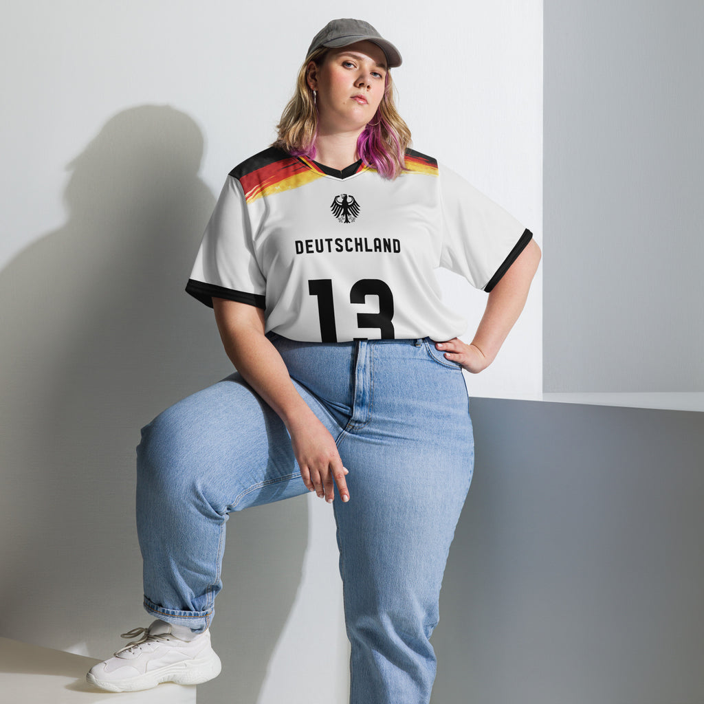 all-over-print-recycled-unisex-sports-jersey-Germany Horizon-edition-soccer-jersey-black-sleeves-with-tricolor-brushstroke-band-and-gold red black-trim-pattern-premium-national-team-fanwear-model-front-view2-female