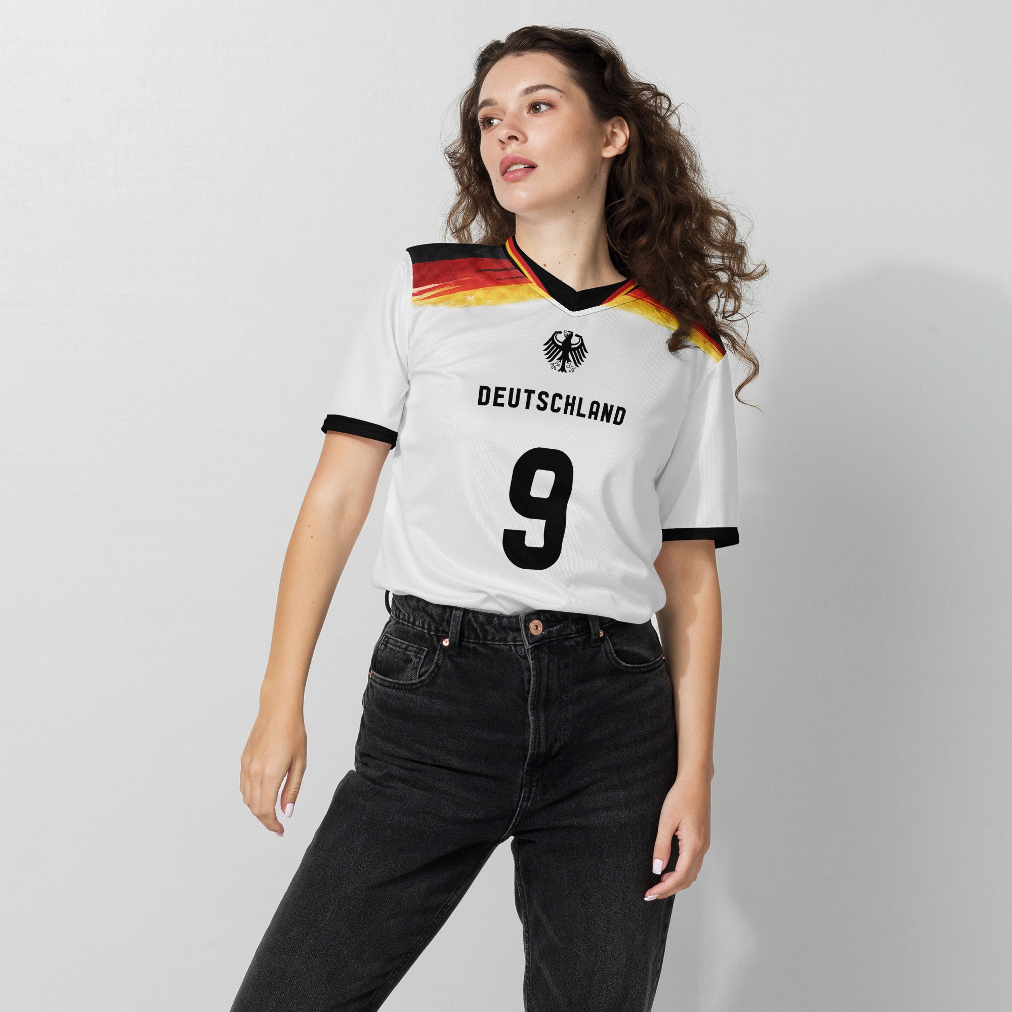 all-over-print-recycled-unisex-sports-jersey-#5-Germany Horizon-edition-soccer-jersey-black-sleeves-with-tricolor-brushstroke-band-and-gold red black-trim-pattern-premium-national-team-fanwear-female-model-front-view