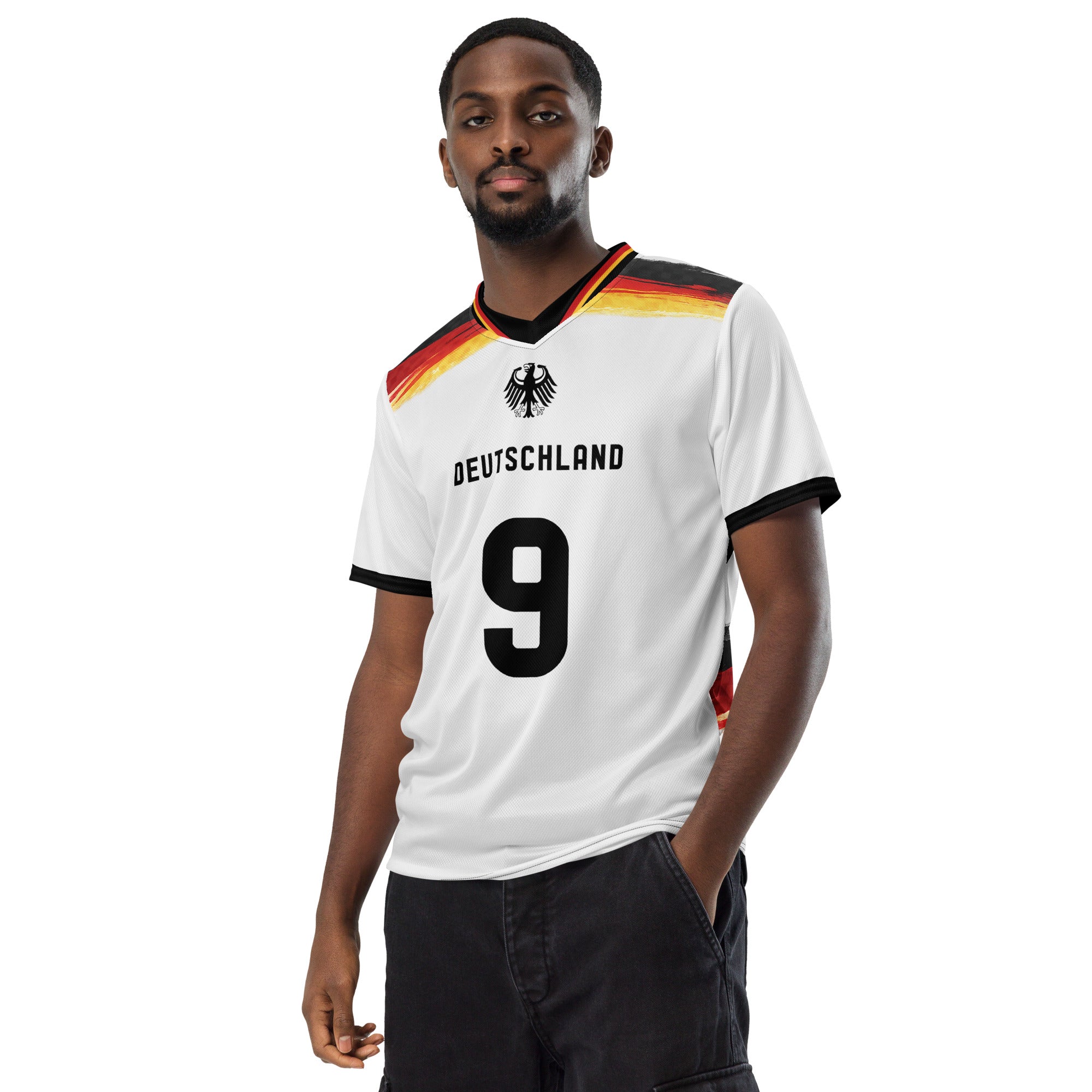 all-over-print-recycled-unisex-sports-jersey-Germany Horizon-edition-soccer-jersey-black-sleeves-with-tricolor-brushstroke-band-and-gold red black-trim-pattern-premium-national-team-fanwear-model-front-view-male-model