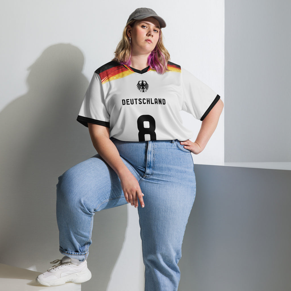 all-over-print-recycled-unisex-sports-jersey-Germany Horizon-edition-soccer-jersey-black-sleeves-with-tricolor-brushstroke-band-and-gold red black-trim-pattern-premium-national-team-fanwear-model-front-view2-female