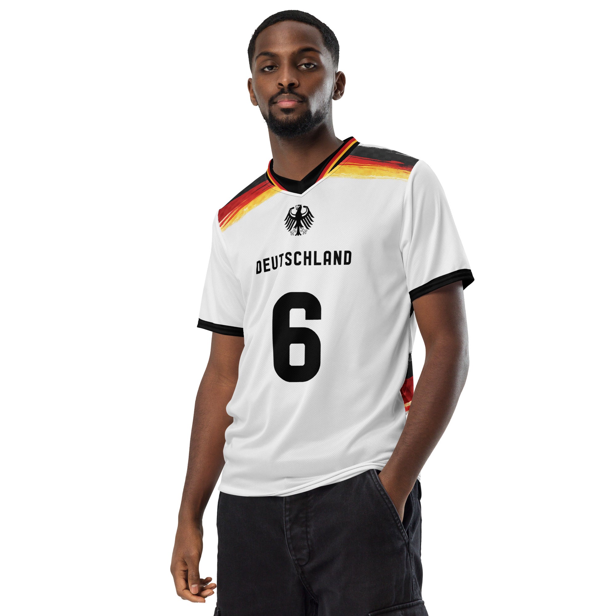 all-over-print-recycled-unisex-sports-jersey-Germany Horizon-edition-soccer-jersey-black-sleeves-with-tricolor-brushstroke-band-and-gold red black-trim-pattern-premium-national-team-fanwear-model-front-view-male-model