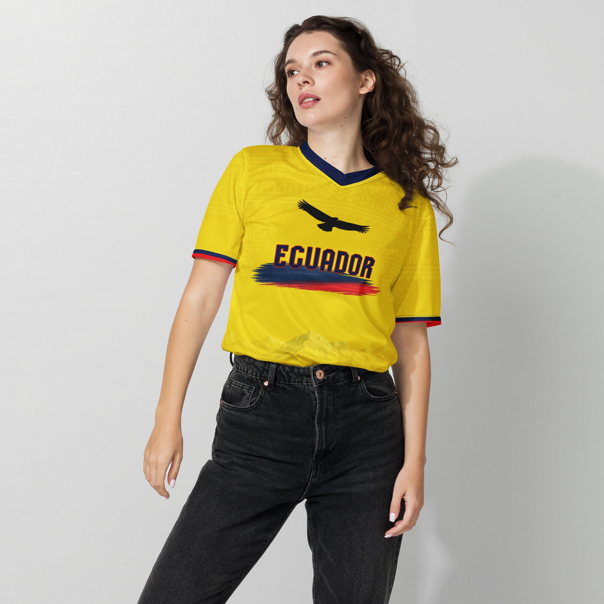 all-over-print-recycled-unisex-sports-jersey-Ecuador-Condor-soccer-jersey-yellow-base-with-mountain-silhouette-and-navy red-accents-premium-national-team-fanwear-female-model-front-view