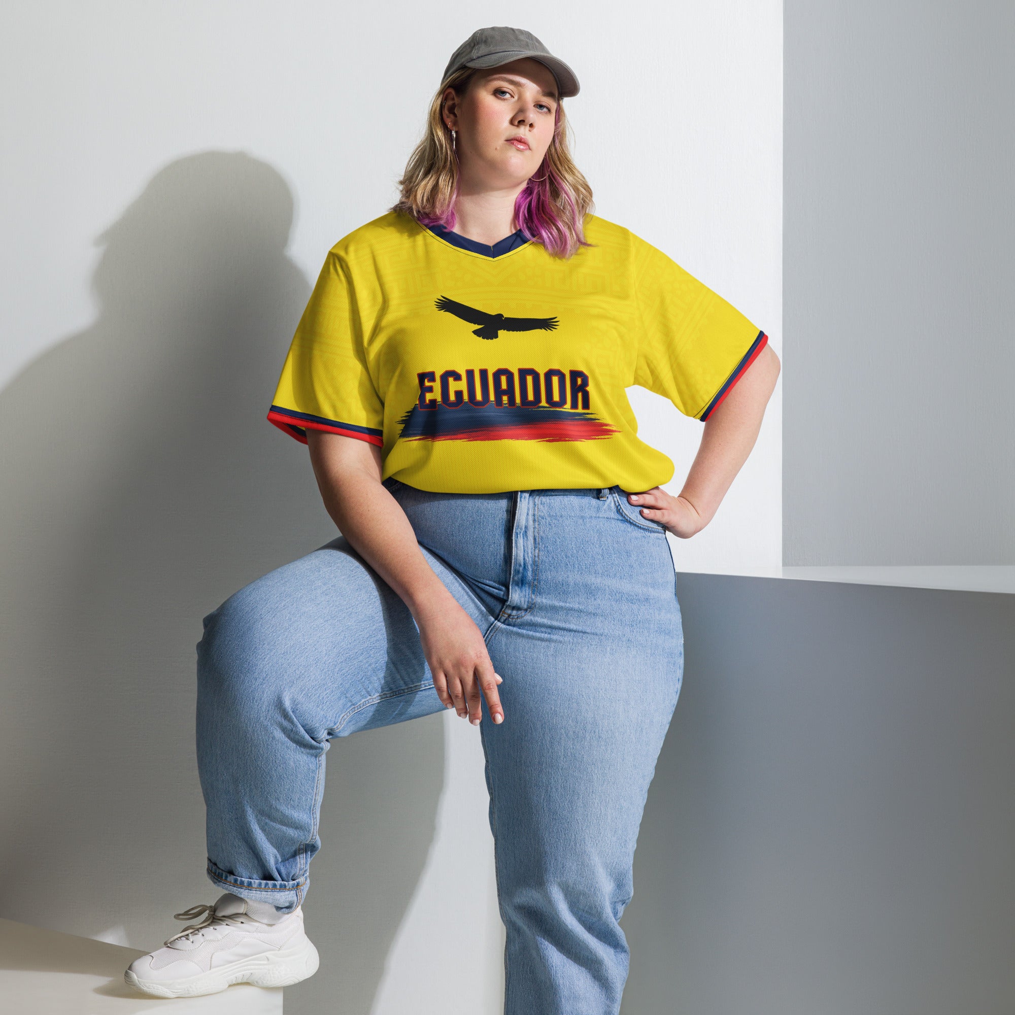 all-over-print-recycled-unisex-sports-jersey-Ecuador-Condor-soccer-jersey-yellow-base-with-mountain-silhouette-and-navy red-accents-premium-national-team-fanwear-model-front-view2-female