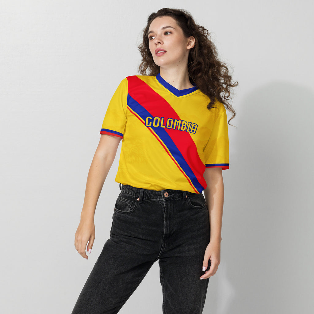 all-over-print-recycled-unisex-sports-jersey-Colombia-Pasión-Cafetera-soccer-jersey-golden-base-with-tricolor-sash-and-coffee leaf-motifs-premium-national-team-fanwear-female-model-front-view