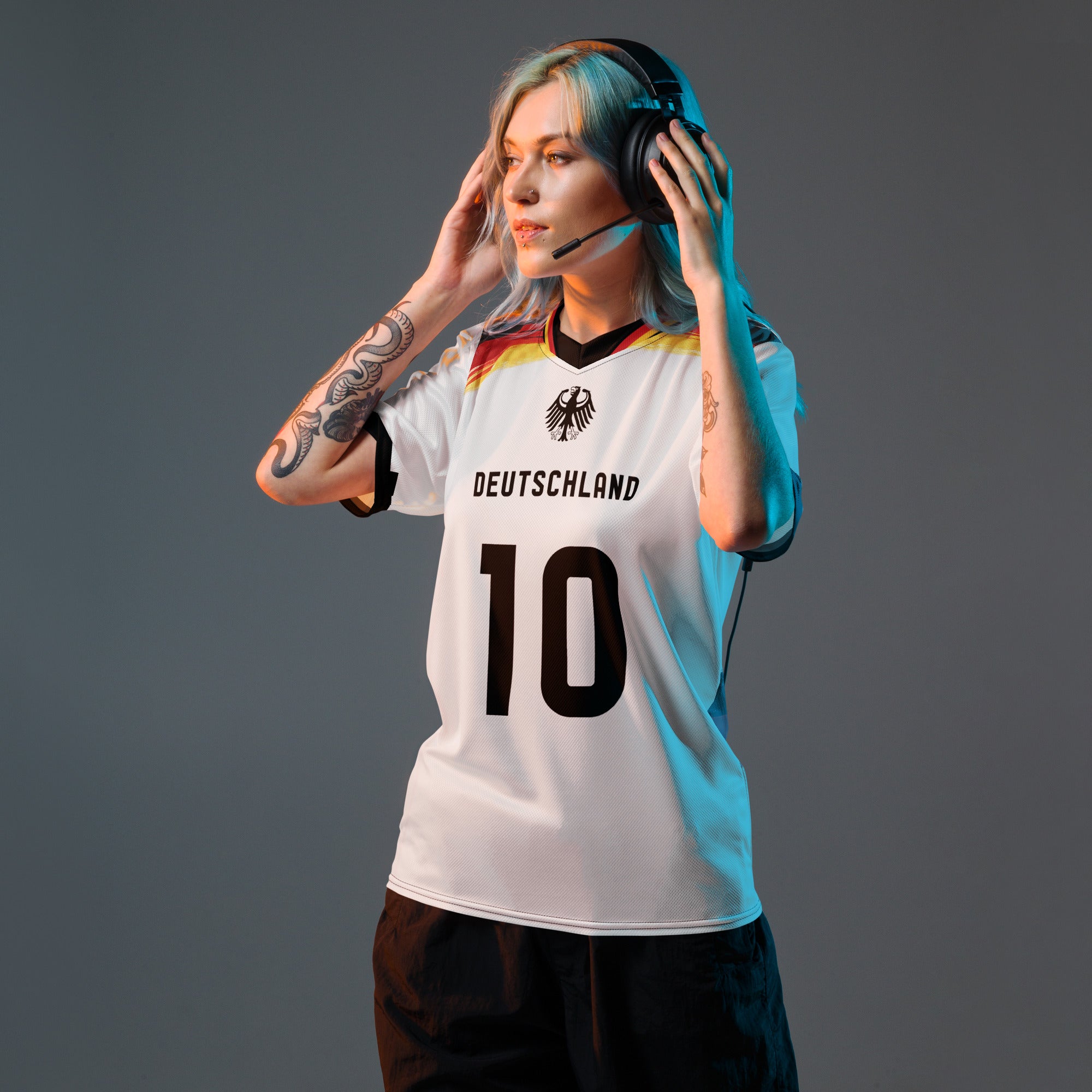 all-over-print-recycled-unisex-sports-jersey-Germany Horizon-edition-soccer-jersey-black-sleeves-with-tricolor-brushstroke-band-and-gold red black-trim-pattern-premium-national-team-fanwear-model-front-view-female-model