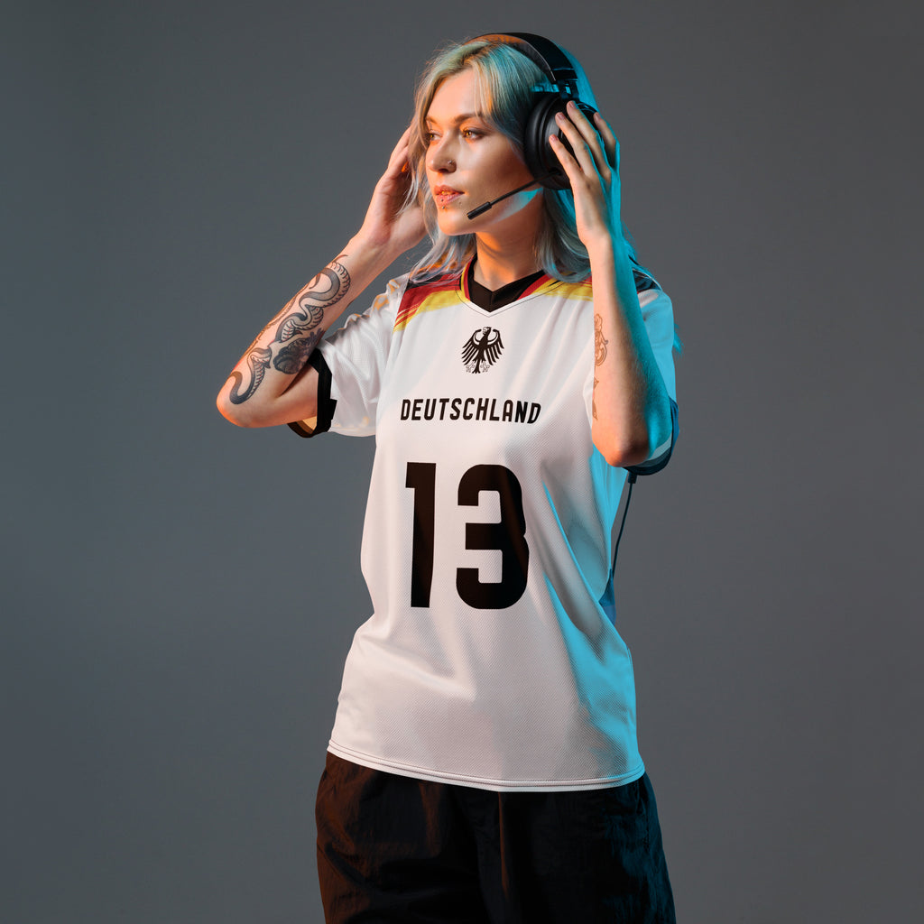 all-over-print-recycled-unisex-sports-jersey-Germany Horizon-edition-soccer-jersey-black-sleeves-with-tricolor-brushstroke-band-and-gold red black-trim-pattern-premium-national-team-fanwear-model-front-view-female-model