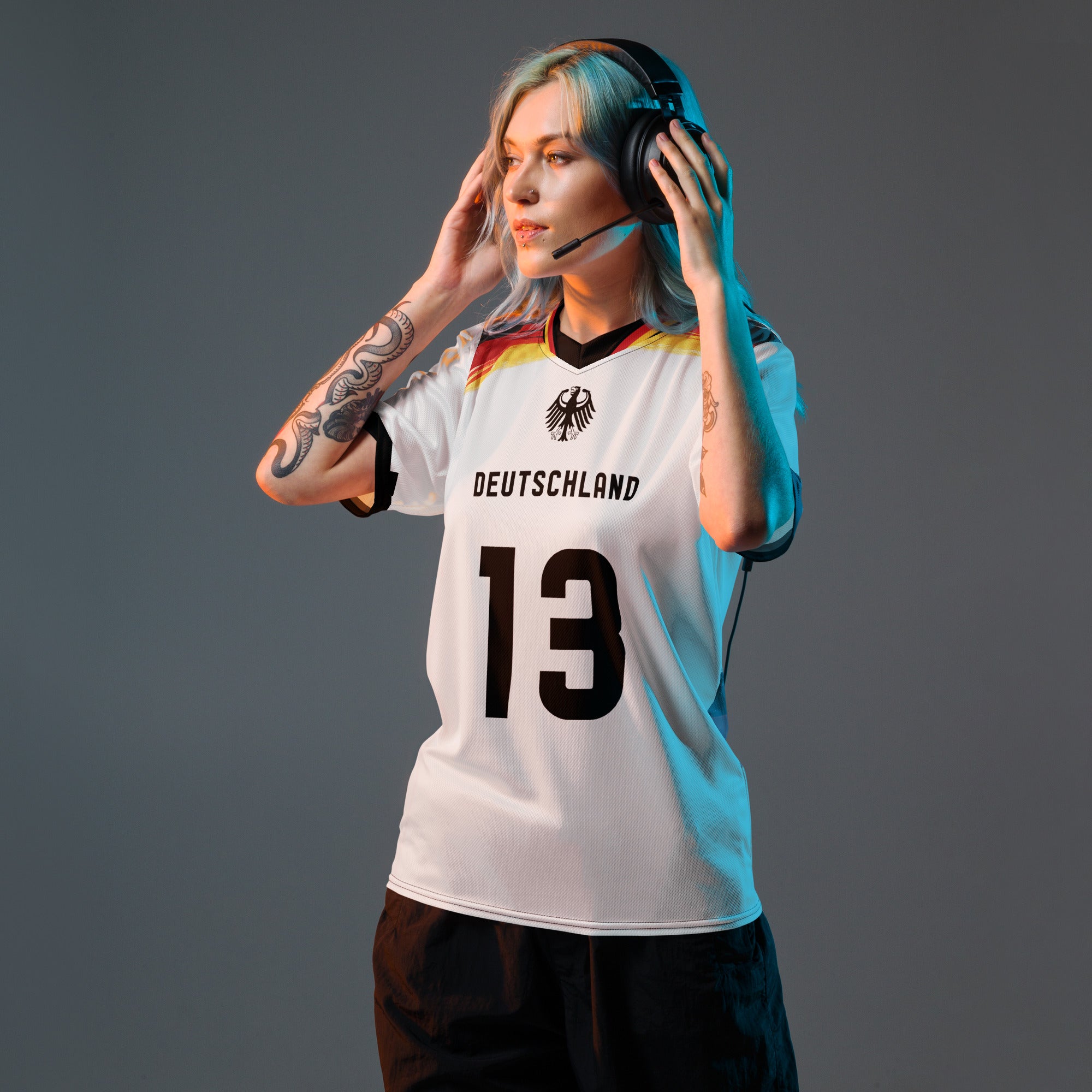 all-over-print-recycled-unisex-sports-jersey-Germany Horizon-edition-soccer-jersey-black-sleeves-with-tricolor-brushstroke-band-and-gold red black-trim-pattern-premium-national-team-fanwear-model-front-view-female-model