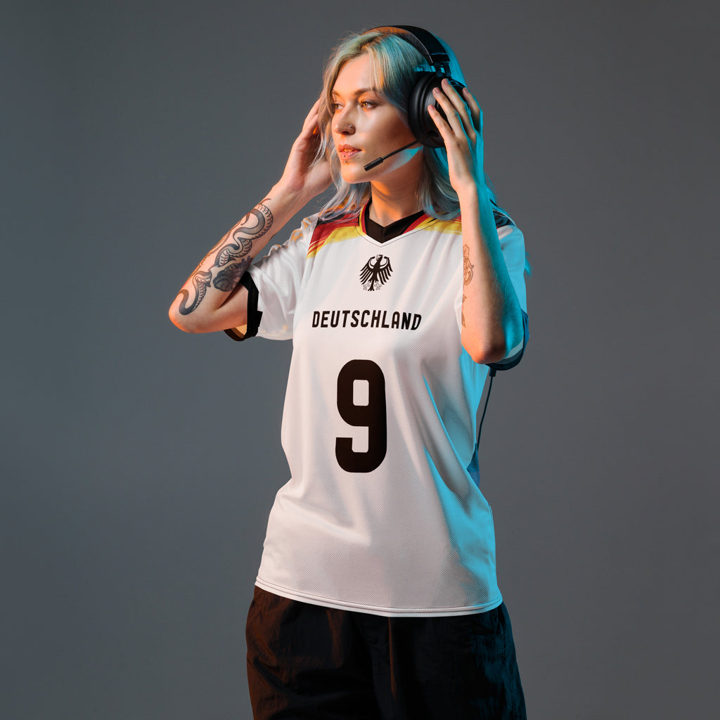 all-over-print-recycled-unisex-sports-jersey-Germany Horizon-edition-soccer-jersey-black-sleeves-with-tricolor-brushstroke-band-and-gold red black-trim-pattern-premium-national-team-fanwear-model-front-view-female-model