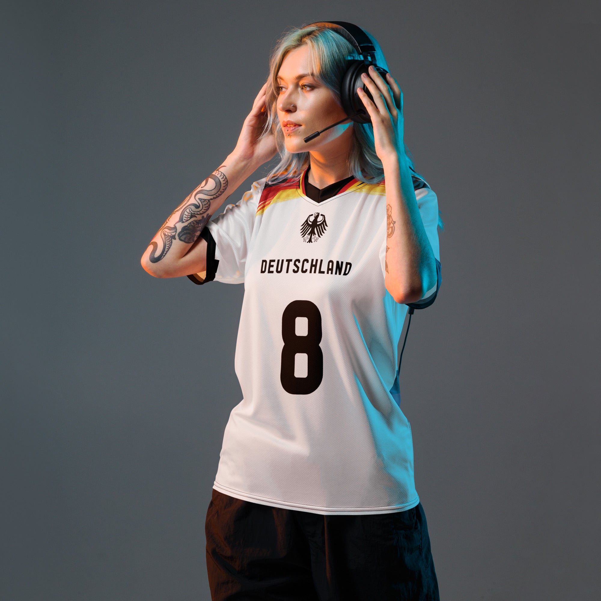 all-over-print-recycled-unisex-sports-jersey-Germany Horizon-edition-soccer-jersey-black-sleeves-with-tricolor-brushstroke-band-and-gold red black-trim-pattern-premium-national-team-fanwear-model-front-view-female-model
