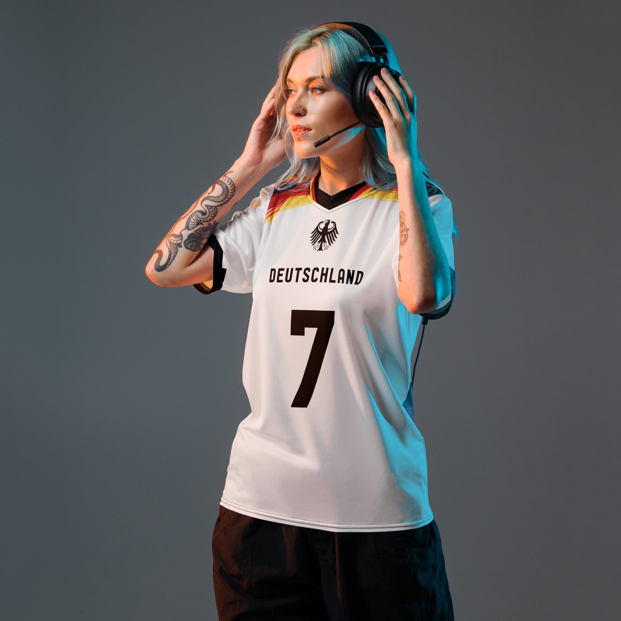 all-over-print-recycled-unisex-sports-jersey-Germany Horizon-edition-soccer-jersey-black-sleeves-with-tricolor-brushstroke-band-and-gold red black-trim-pattern-premium-national-team-fanwear-model-front-view-female-model