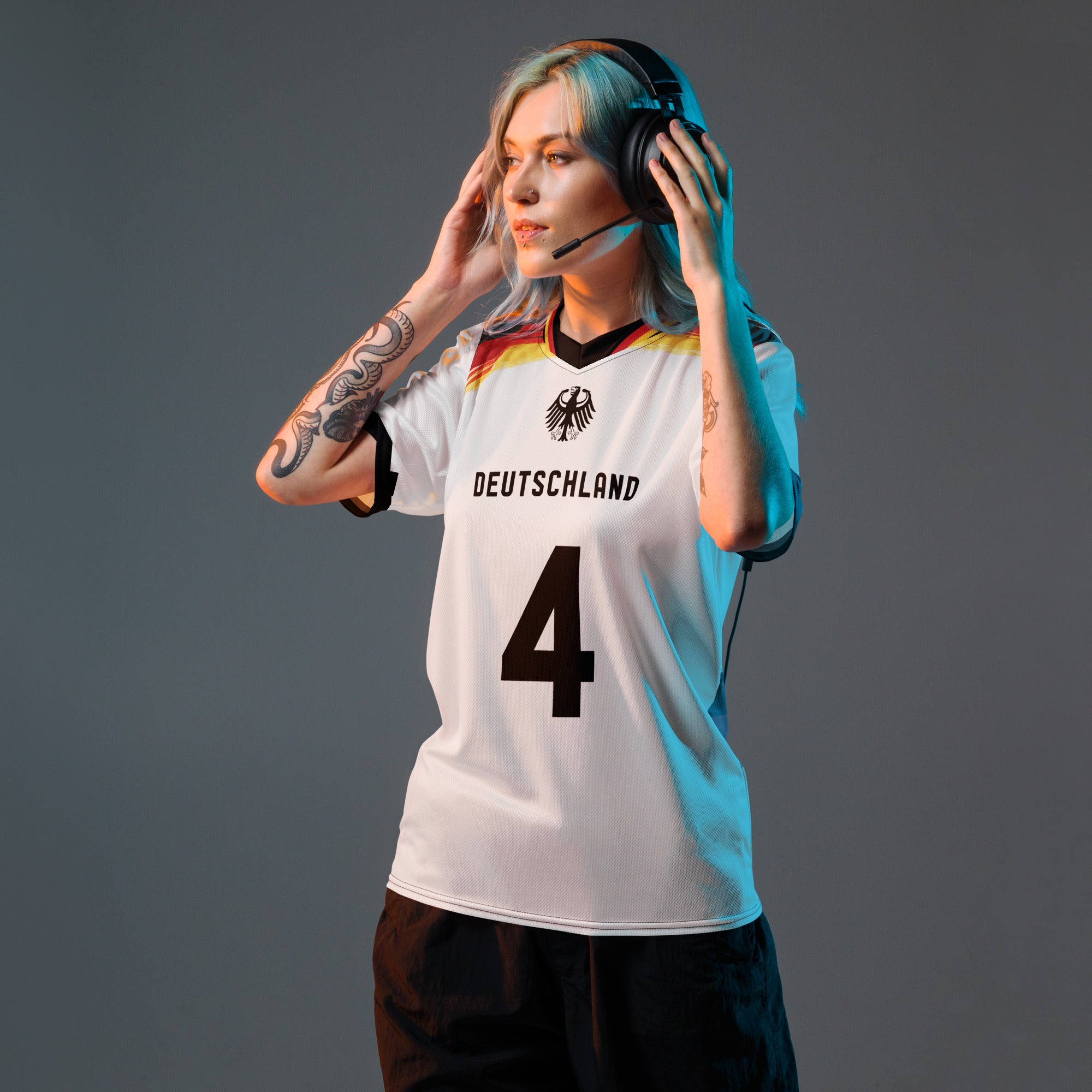all-over-print-recycled-unisex-sports-jersey-Germany Horizon-edition-soccer-jersey-black-sleeves-with-tricolor-brushstroke-band-and-gold red black-trim-pattern-premium-national-team-fanwear-model-front-view-female-model