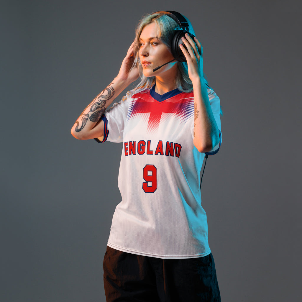 all-over-print-recycled-unisex-sports-jersey-#9-England-Lionheart-edition-soccer-jersey-vibrant-yellow-with-blue-diagonal-strike-and-geometric-pattern-premium-national-team-fanwear-model-front-view-female-model