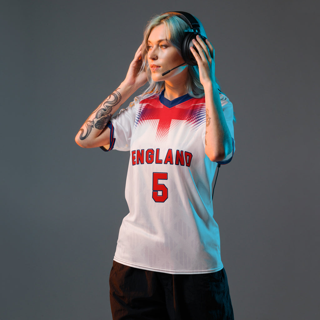 all-over-print-recycled-unisex-sports-jersey-#5-England-Lionheart-edition-soccer-jersey-vibrant-yellow-with-blue-diagonal-strike-and-geometric-pattern-premium-national-team-fanwear-model-front-view-female-model