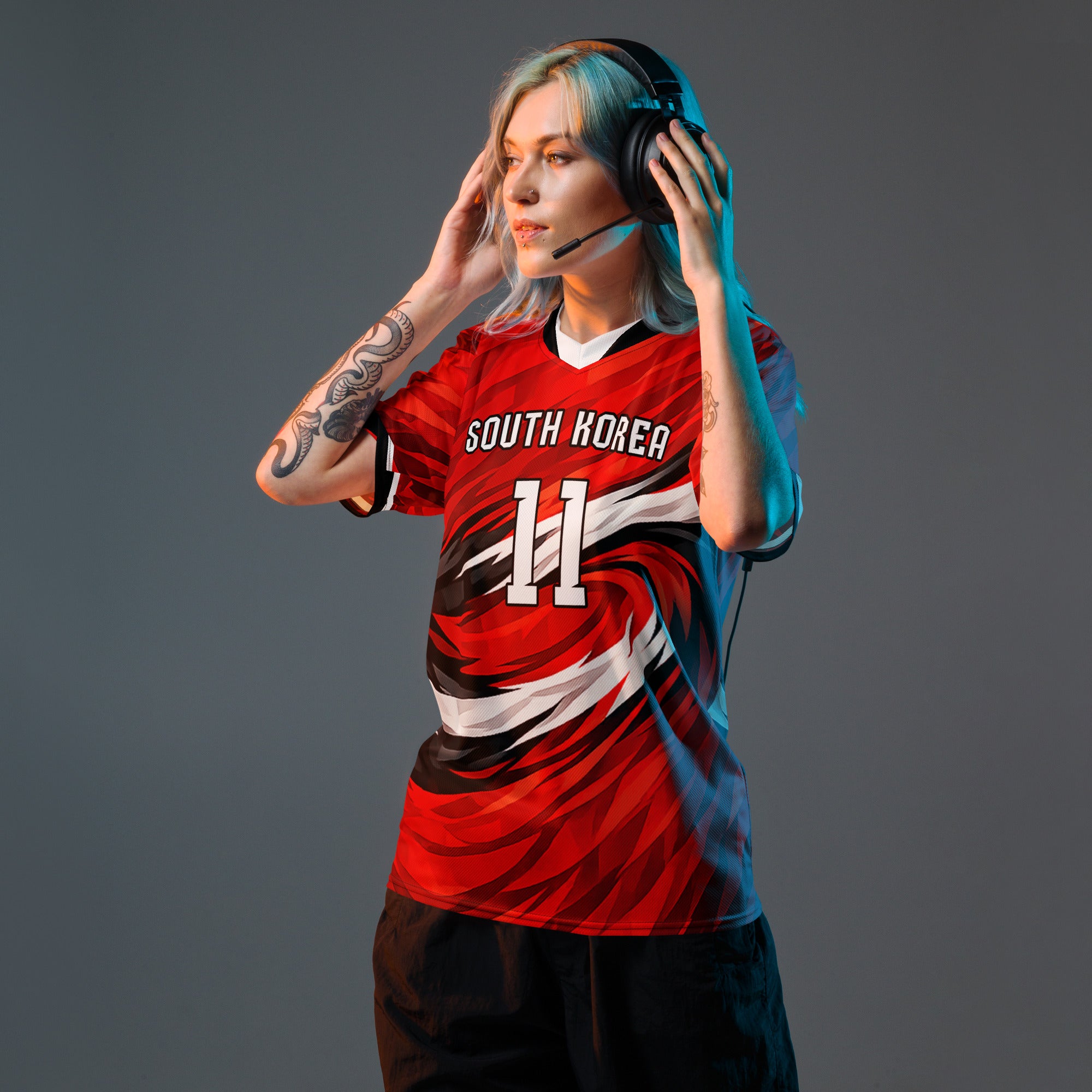 all-over-print-recycled-unisex-sports-jersey-South-Korea-Taegeuk-soccer-jersey- crimson-base-with-sweeping-red black white-wave-design-premium-national-team-fanwear-model-front-view-female-model