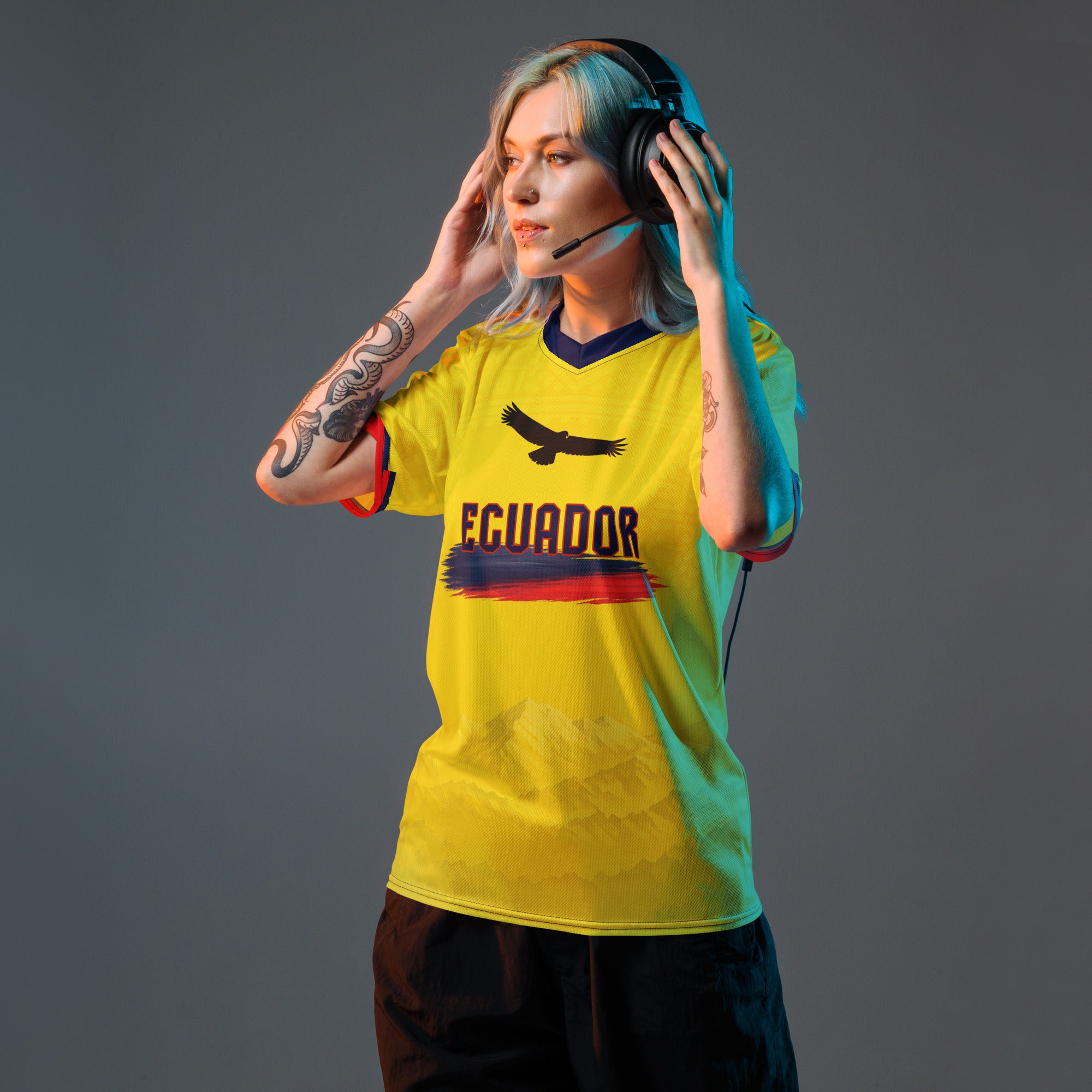 all-over-print-recycled-unisex-sports-jersey-Ecuador-Condor-soccer-jersey-yellow-base-with-mountain-silhouette-and-navy red-accents-premium-national-team-fanwear-model-front-view-female-model