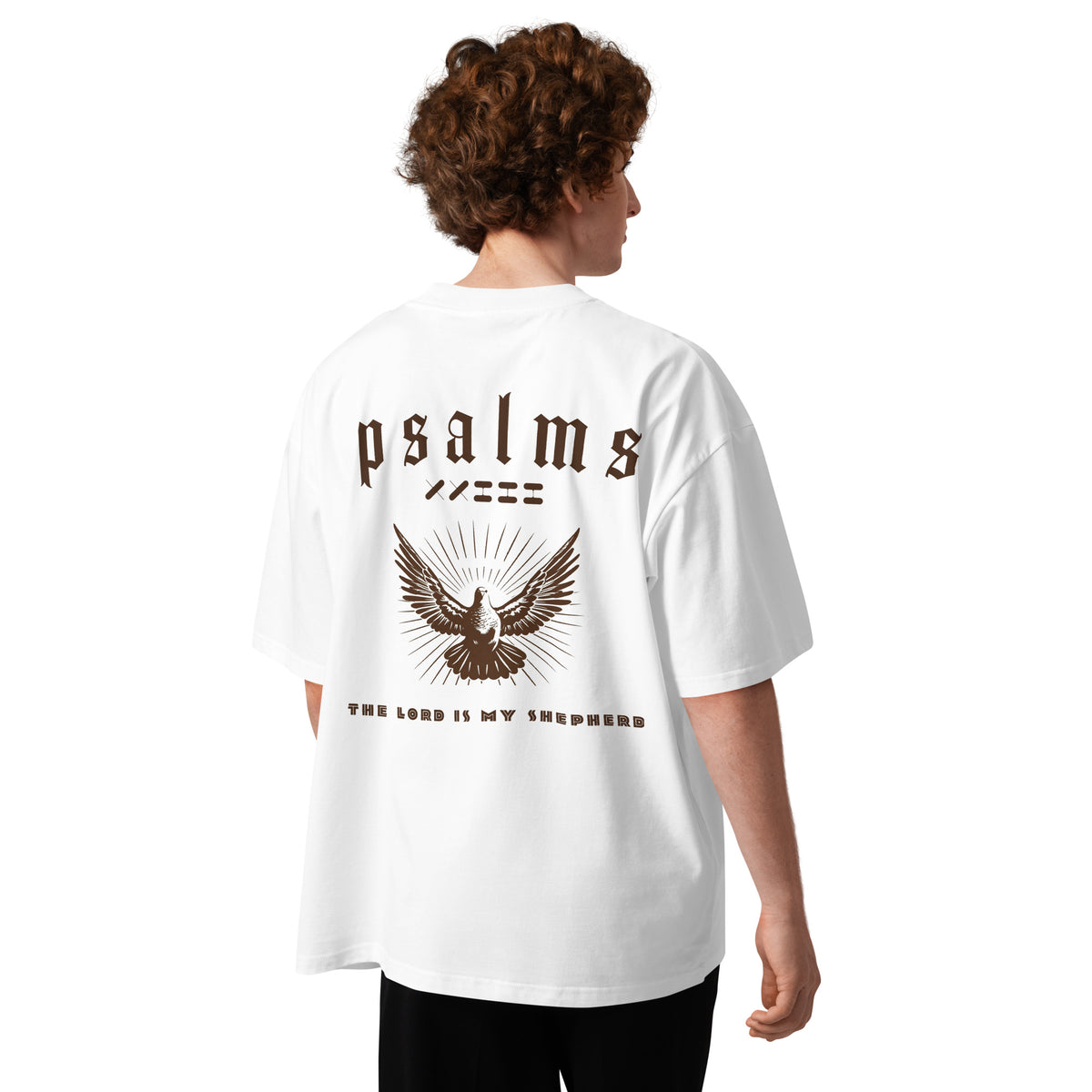 Male model wearing Oerigin's white oversized heavyweight streetwear "psalms 23" t-shirt on the back. 